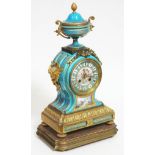 A French 19th century ormolu and Sevres style blue porcelain clock having urn top, twin cherub
