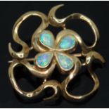 A modern Arts & Crafts style hallmarked 9ct gold brooch set with four pear shaped precious opal