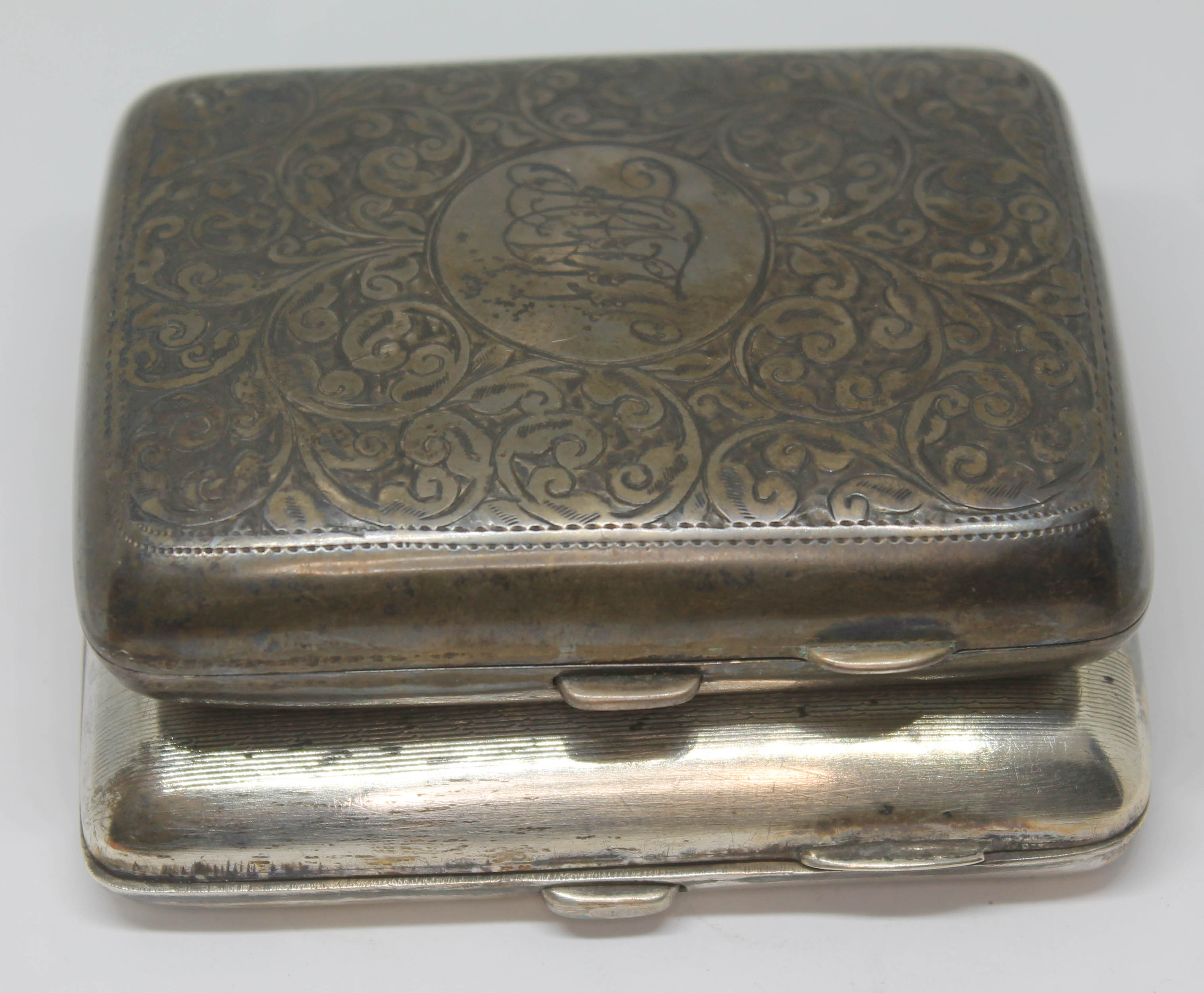 Two hallmarked silver cigarette cases, wt. 7oz.