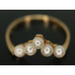 A cultured pearl wishbone ring, marked 'K18', gross wt. 1.44g, size L.