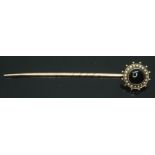 A black onyx cabochon and pearl stick pin, unmarked, gross wt. 3.74g, head diam. 14mm.