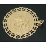 A Chinese pendant, diam. 29mm, marked '14K585', wt. 4.14g.