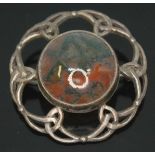 A Scottish silver target brooch set with a central moss agate cabochon.