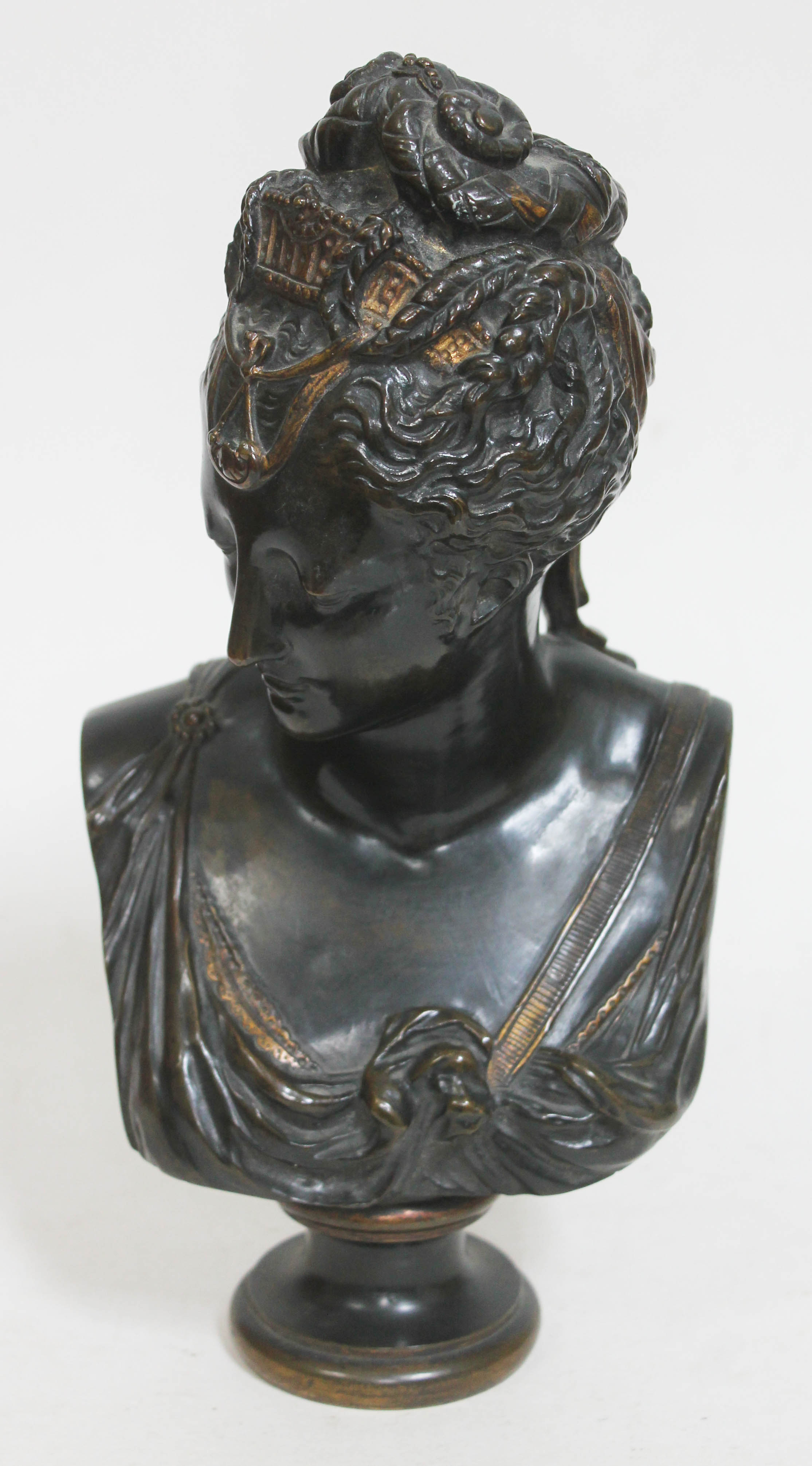 A French 19th century bronze after the antique depicting a Greek female with gilt head dress and