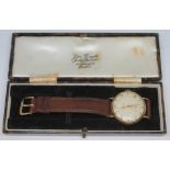 A 1950s hallmarked 9ct gold Garrard wristwatch with champagne signed dial, alternate hour markers