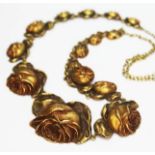 A French Art Nouveau necklace formed from fifteen linked stylised flowers, fastening link next to