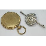 A 1920s silver cocktail watch brooch and a 19th century yellow metal locket.