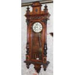 A late 19th century walnut cased double weight driven Vienna wall clock, length 135cm.