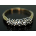 A five stone diamond ring, 18ct gold import marks, gross wt. 2.03g, size K (band bent).