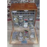 A wooden cabinet of watch spares and repairs.