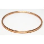 A contemporary 'rose gold' bangle by David Burns, marked '9ct', wt. 21.73g, diam. approx. 7cm.