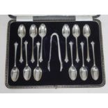 A cased set of twelve hallmarked silver teaspoons and matching sugar tongs.