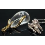 A quartz rock crystal pendant mounted in 9ct gold gold, together with a silver poodle charm.