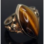 A hallmarked 9ct gold ring set with a marquis cabochon cut tiger's eye, gross wt. 4.39g, size M.