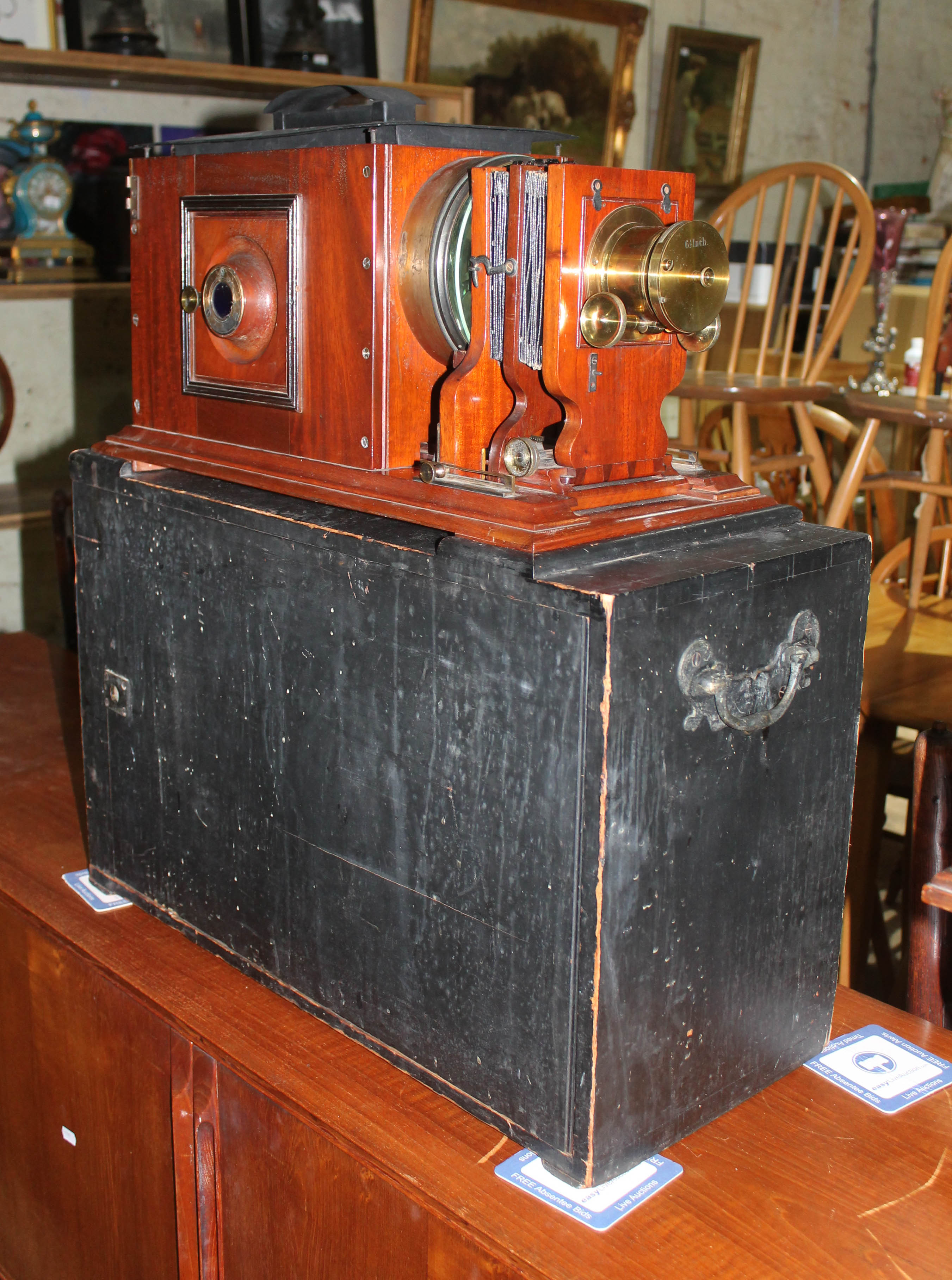 A boxed magic lantern type projector.