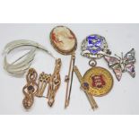 A mixed lot comprising a hallmarked 9ct gold cricket medal, four bar brooches, gross wt. 12.66g