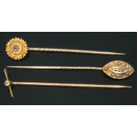 A group of three stick pins, two unmarked set with diamonds/pearls and another marked '15ct',
