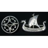 Two modern Scottish Celtic style silver brooches by Ola M Gorie, one fromed as a Viking ship, length