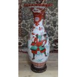 A large Japanese porcelain vase with crimped and flared rim, carved wooden stand, height 69cm.
