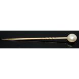 A natural pearl stick pin circa 1900, the oval beaded pearl measuring approx. 7.98mm x 6.92mm,