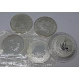 A group of six 1oz fine silver coins (one not pictured).