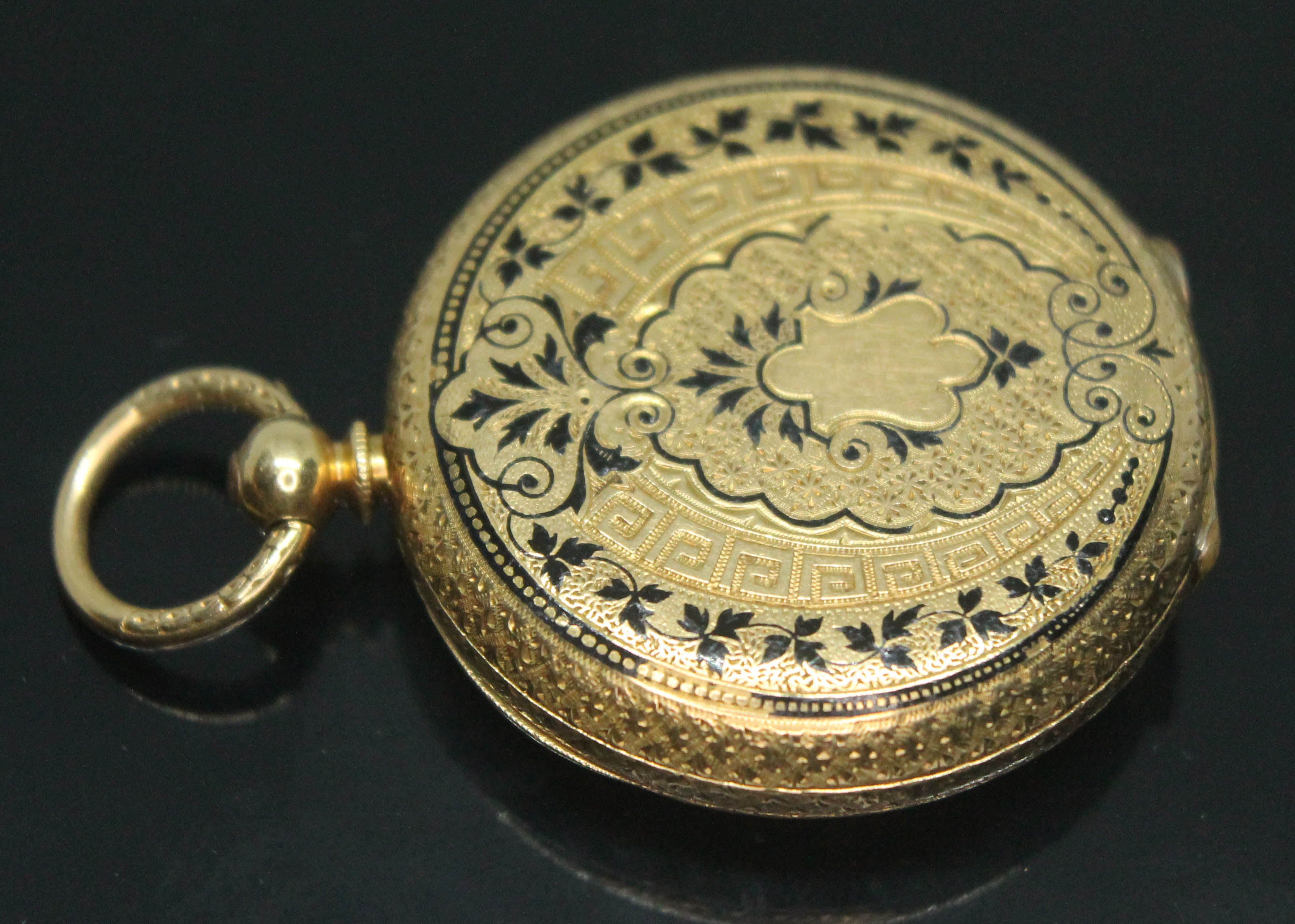 A ladies bright engraved pocket watch, marked '18K', diam. 32mm, gross wt. 26.67g.