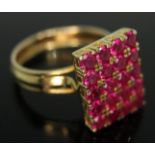 A yellow metal and synthetic pave set ruby ring, indistinctly marked, gross wt. 7.60g, size