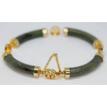 A Chinese yellow metal and nephrite jade bracelet, unmarked, diam. approx. 6.5cm.