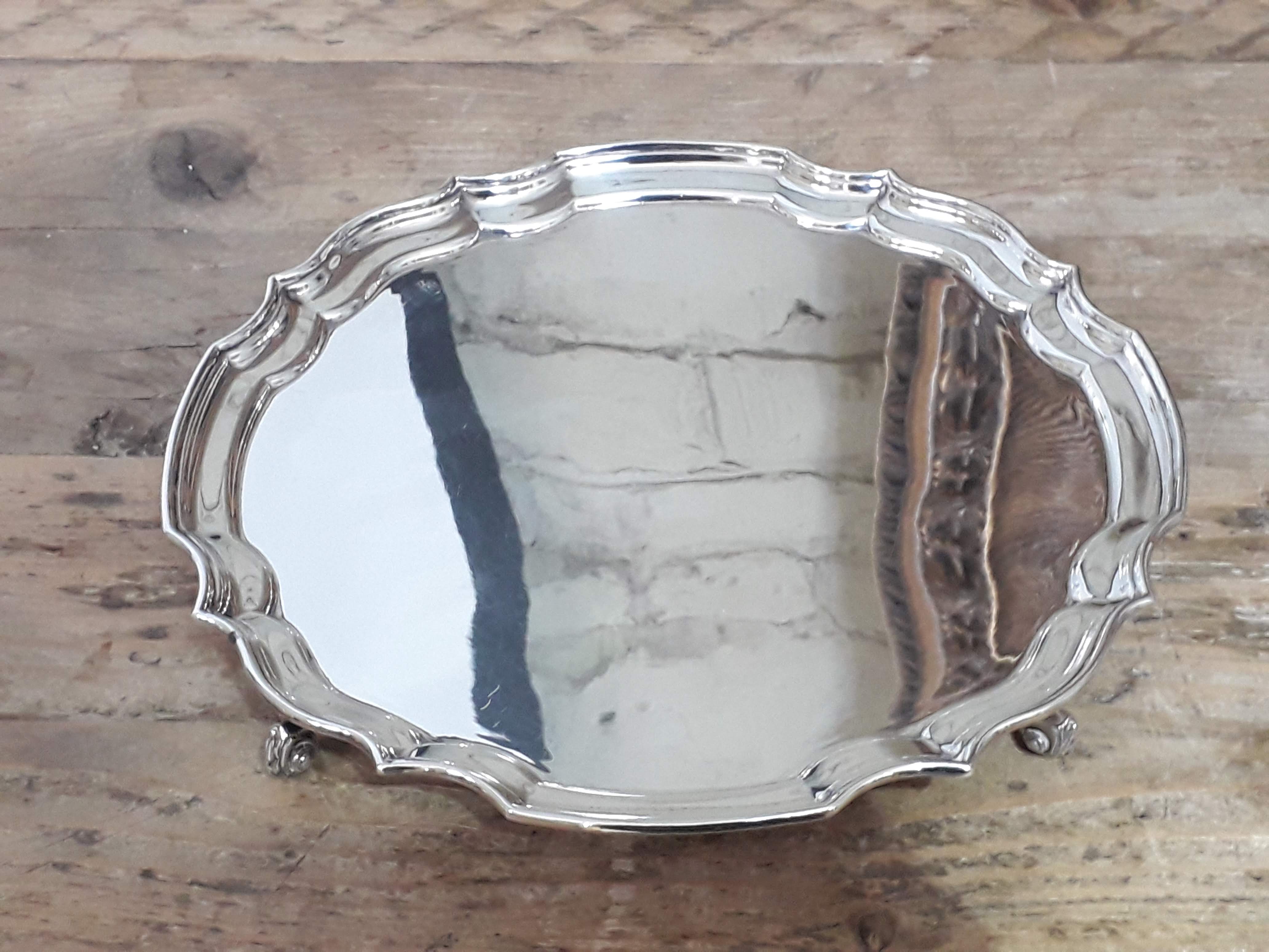 A four footed silver salver, Sheffield 1973, wt. 15oz.