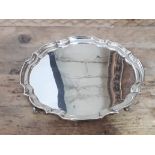 A four footed silver salver, Sheffield 1973, wt. 15oz.