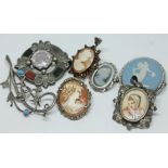 A mixed lot of brooches including a Victorian Scottish type white metal brooch set with an amethyst,
