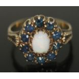 A precious opal and sapphire ring, the setting measuring approx. 13mm x 12mm, hallmarked 9ct gold