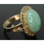 A jadeite jade cabochon ring, greek key border, band marked '14K585', the cabochon measuring approx.