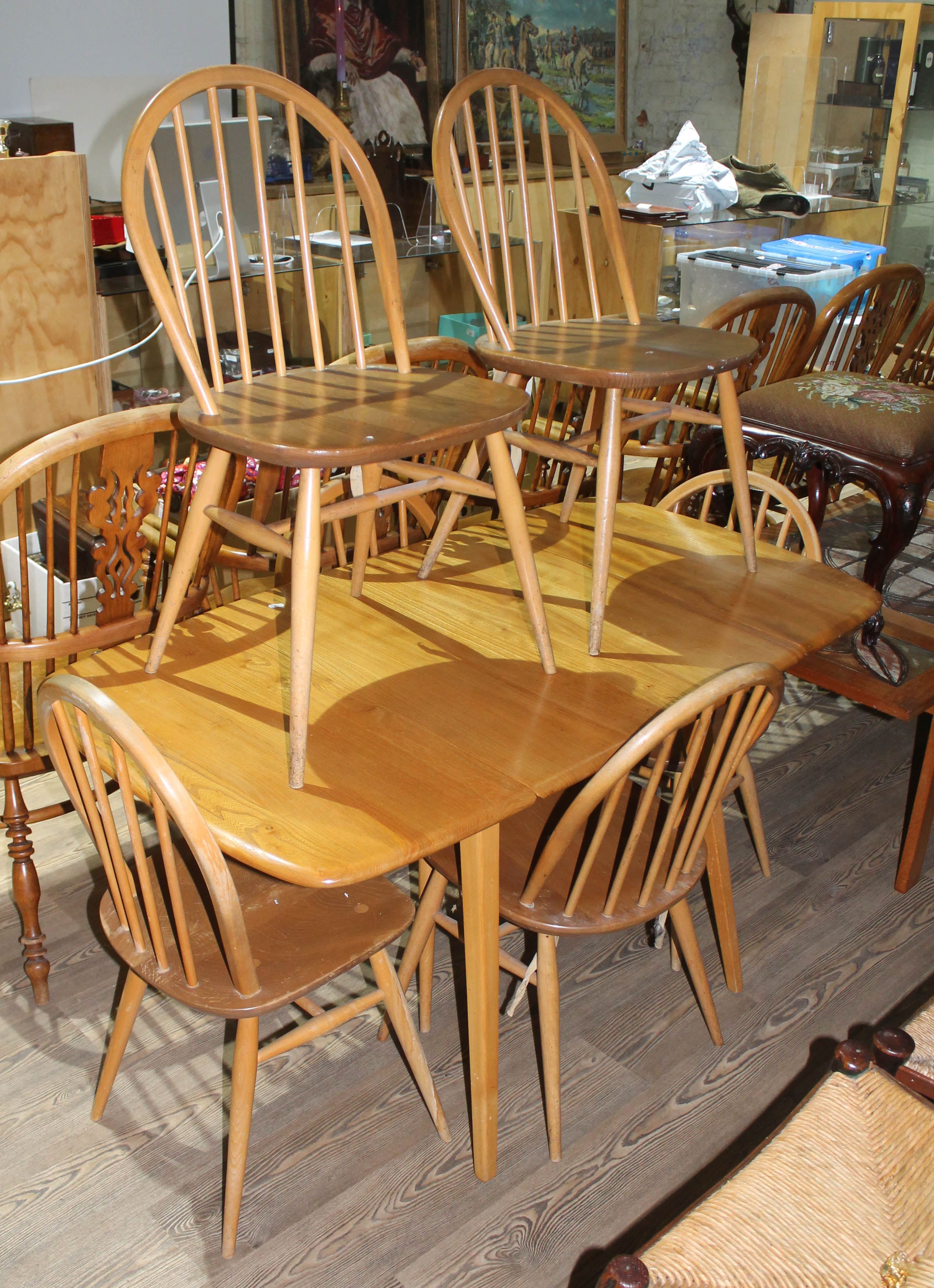 An Ercol blonde drop leaf table and six chairs.