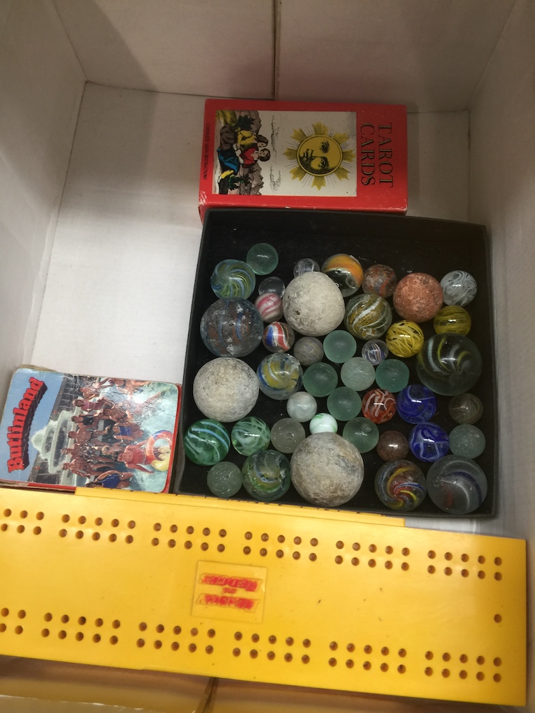 A box of antique marbles, advertising dominoes, Tarot and playing cards Catalogue only, live bidding