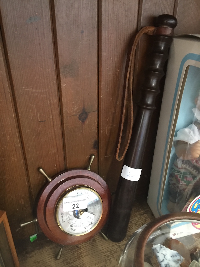 A circular barometer in shape of ship's wheel and a vintage Hiatt & Co police trunkeon. Catalogue