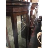 A mahogany bow front glazed display cabinet Catalogue only, live bidding available via our