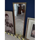 A tall gilded mirror. Catalogue only, live bidding available via our website. If you require P&P