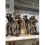 Eight body building trophies and photographs of some 'Mr Wigan' 1985 Catalogue only, live bidding