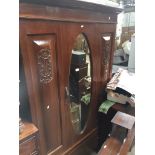 An early 20th century mahogany mirror door wardrobe Catalogue only, live bidding available via our