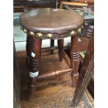 A small milking stool with leather top Catalogue only, live bidding available via our website.