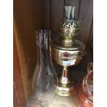 A brass oil lamp. Catalogue only, live bidding available via our website. Please note if you require