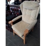 A cloth and wood show wing back armchair Catalogue only, live bidding available via our website.