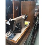 A Singer 201K electric sewing machine in case Catalogue only, live bidding available via our