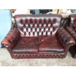 An oxblood leather Chesterfield two seater settee Catalogue only, live bidding available via our