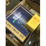 A mixed box of games equipment including glass chess set, dice dominoes, vintage billiard balls