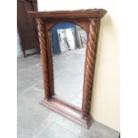A hardwood framed mirror with twist pillars Catalogue only, live bidding available via our