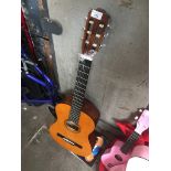 A Hokada acoustic guitar with a "How to play" book. Catalogue only, live bidding available via our