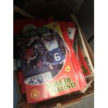 A box of Man United programmes. Catalogue only, live bidding available via our website. Please