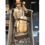 A vintage treen Black Forest cello player and a box of wooden lace bobbins Catalogue only, live